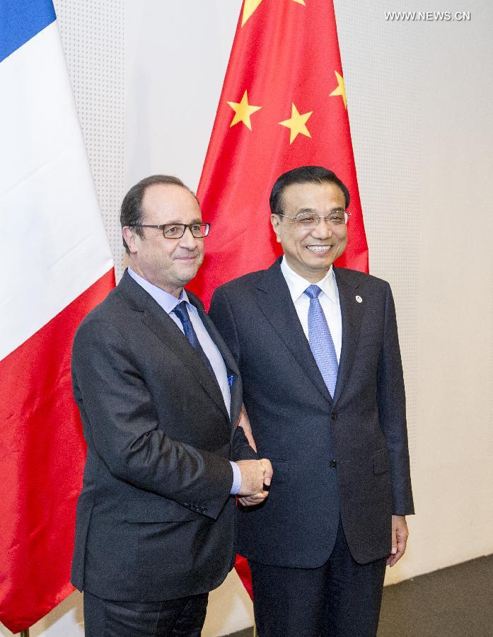 رئيس مجلس الدولة الصيني والرئيس الفرنسي يجتمعان لبحث تعميق العلاقات بين البلدين
