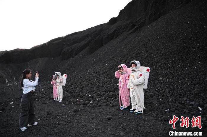 في منغوليا الداخلية، سياح ببدلات رواد الفضاء فوق الأراضي البركانية