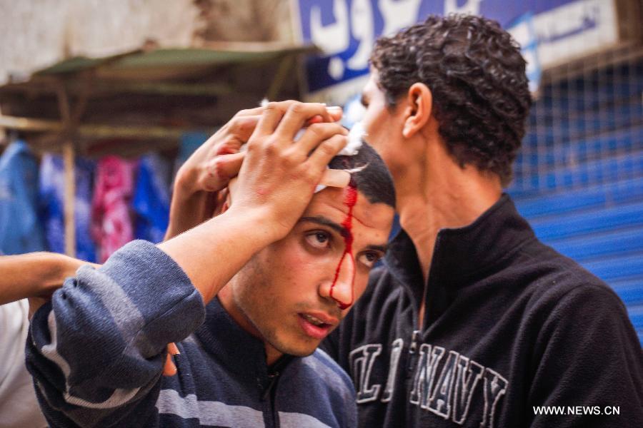 تقرير اخباري: قتيلان و14 مصابا فى اشتباكات بين انصار ومعارضي مرسي 